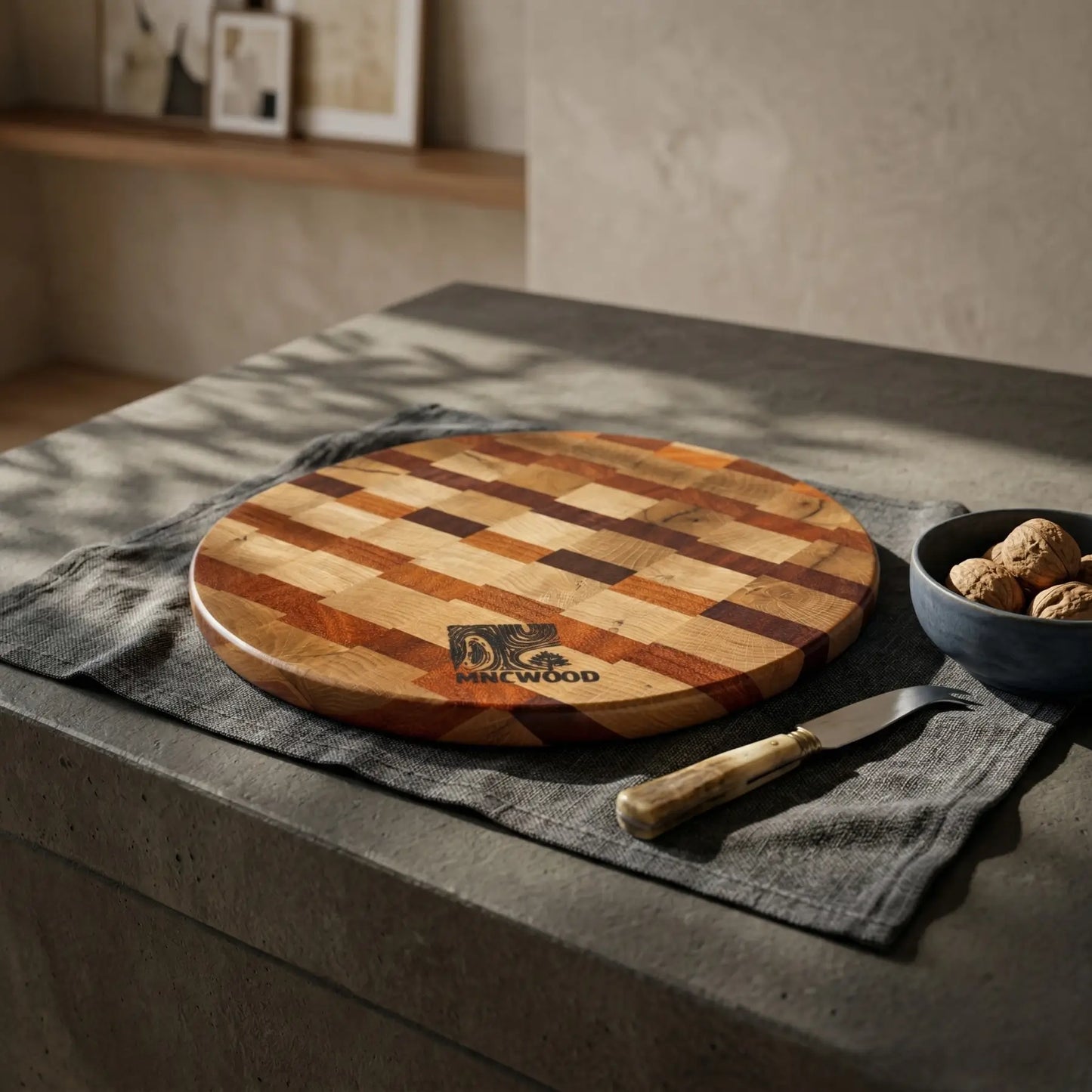 Premium circular wooden serving board 350 mm resting on a kitchen island surrounded by culinary tools.