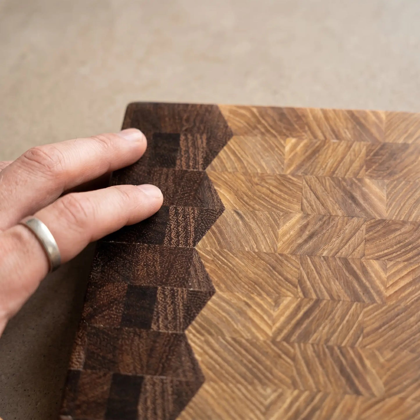 Close-up of dual pattern design with sucupira and ash, handmade end-grain board