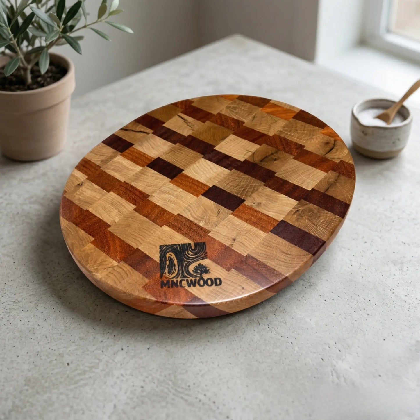 Solid ash and sucupira butcher block 350 mm styled on a light countertop with fresh cooking ingredients.