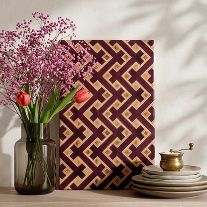 Handmade purpleheart wood cutting board with an optical illusion 3D pattern on a kitchen counter.