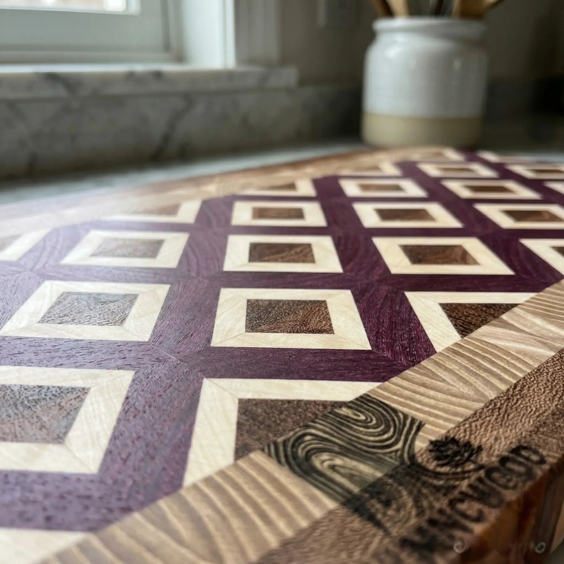 Four hardwood end grain cutting board with diamond lattice design, featuring integrated handles and MNCWOOD logo.