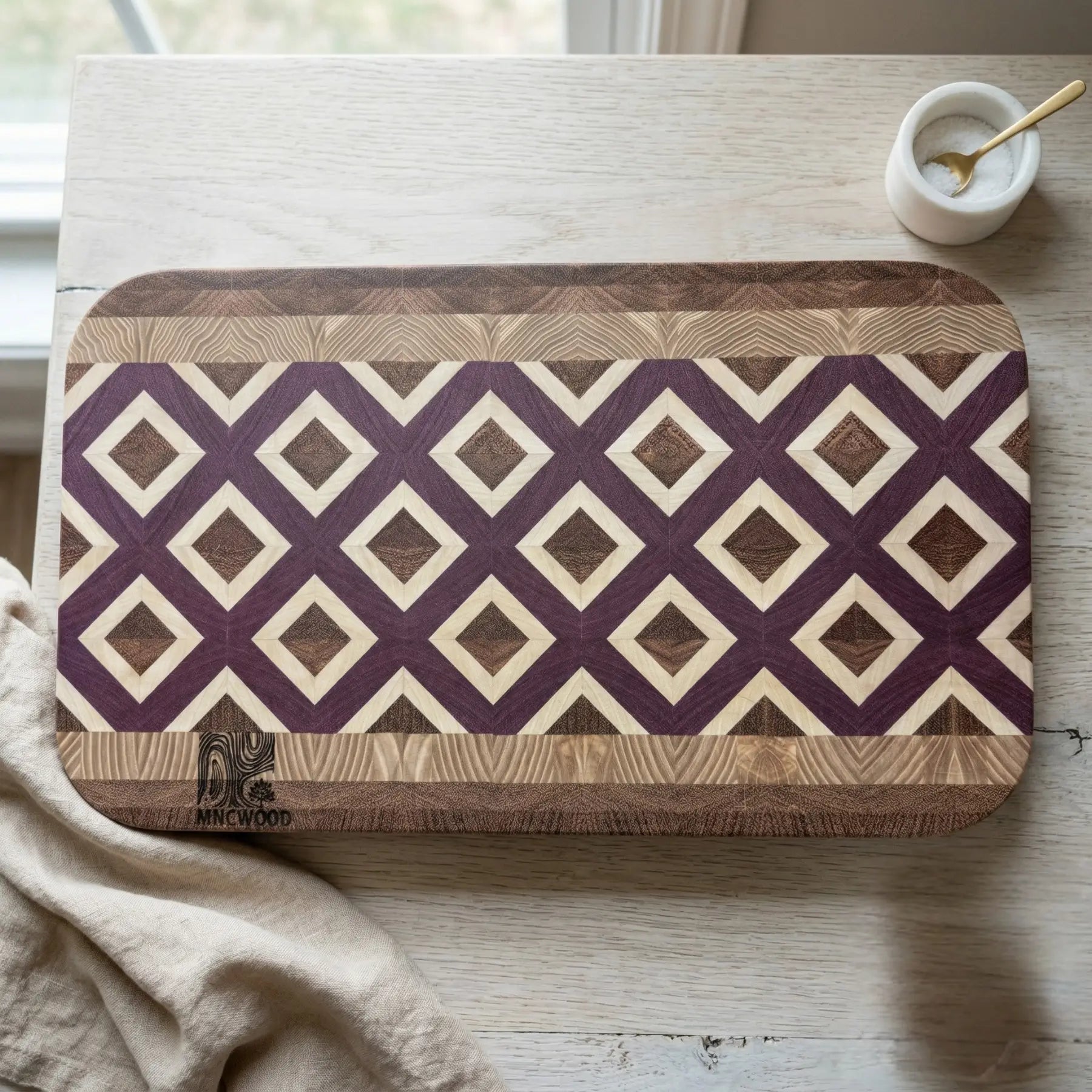MNCWOOD 500x310x40mm end grain cutting board with a geometric diamond lattice pattern in a bright kitchen.
