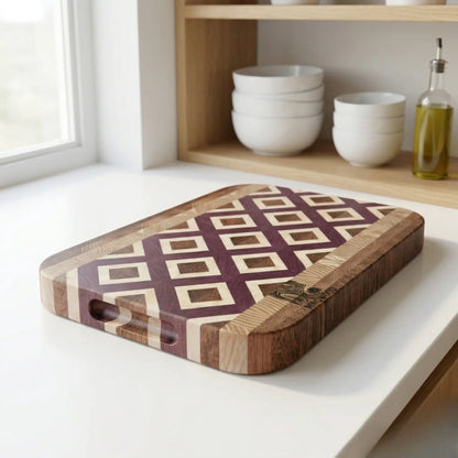 Luxury geometric wood cutting board styled in a modern rustic kitchen with an olive tree in the background.
