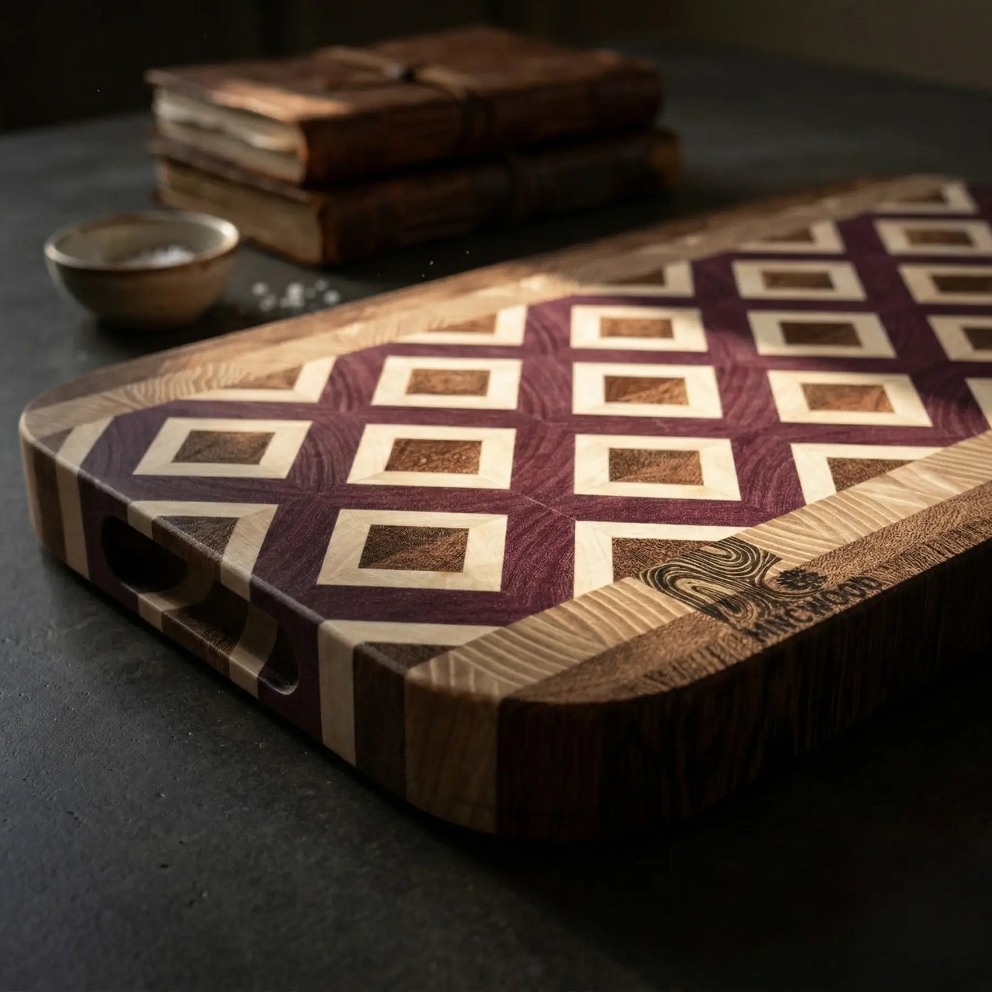 Handcrafted end grain butcher block showing purple and brown wood tones with a diamond lattice pattern.