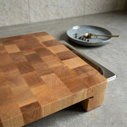 End-grain cutting board with tray holding chopped vegetables, lifestyle prep