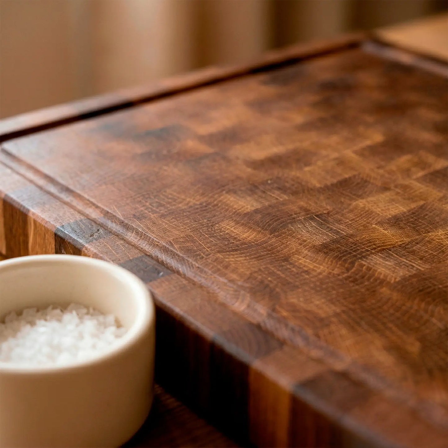 Oak butcher block with carved steak and juices collected in groove