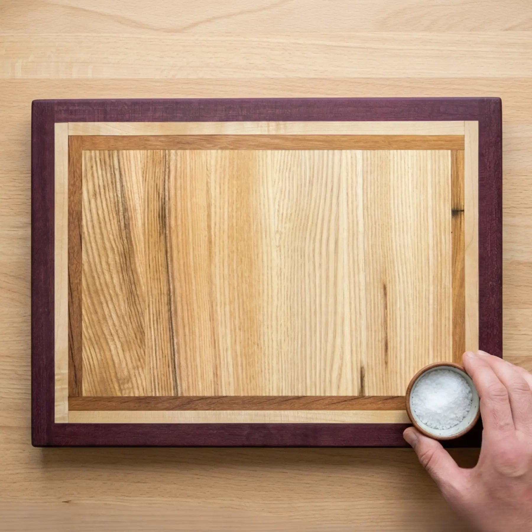 Multi-wood inlay centre on handmade purpleheart frame cutting board