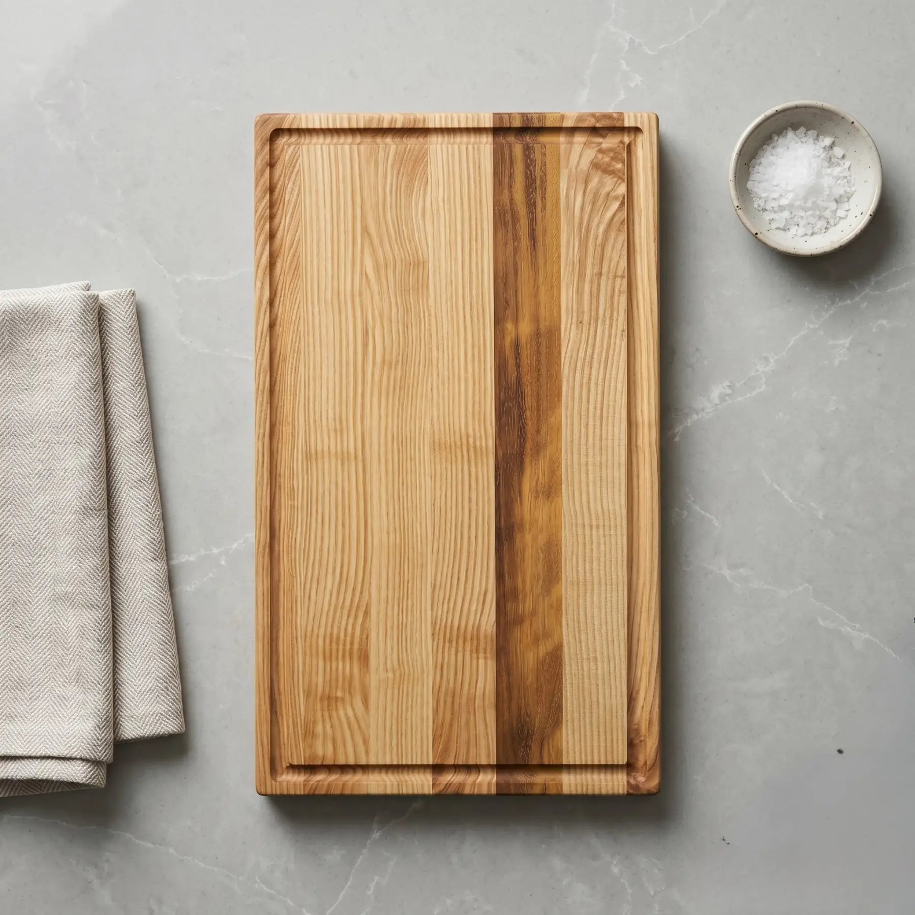 Large ash sapele cutting board at angle showing face-grain figure
